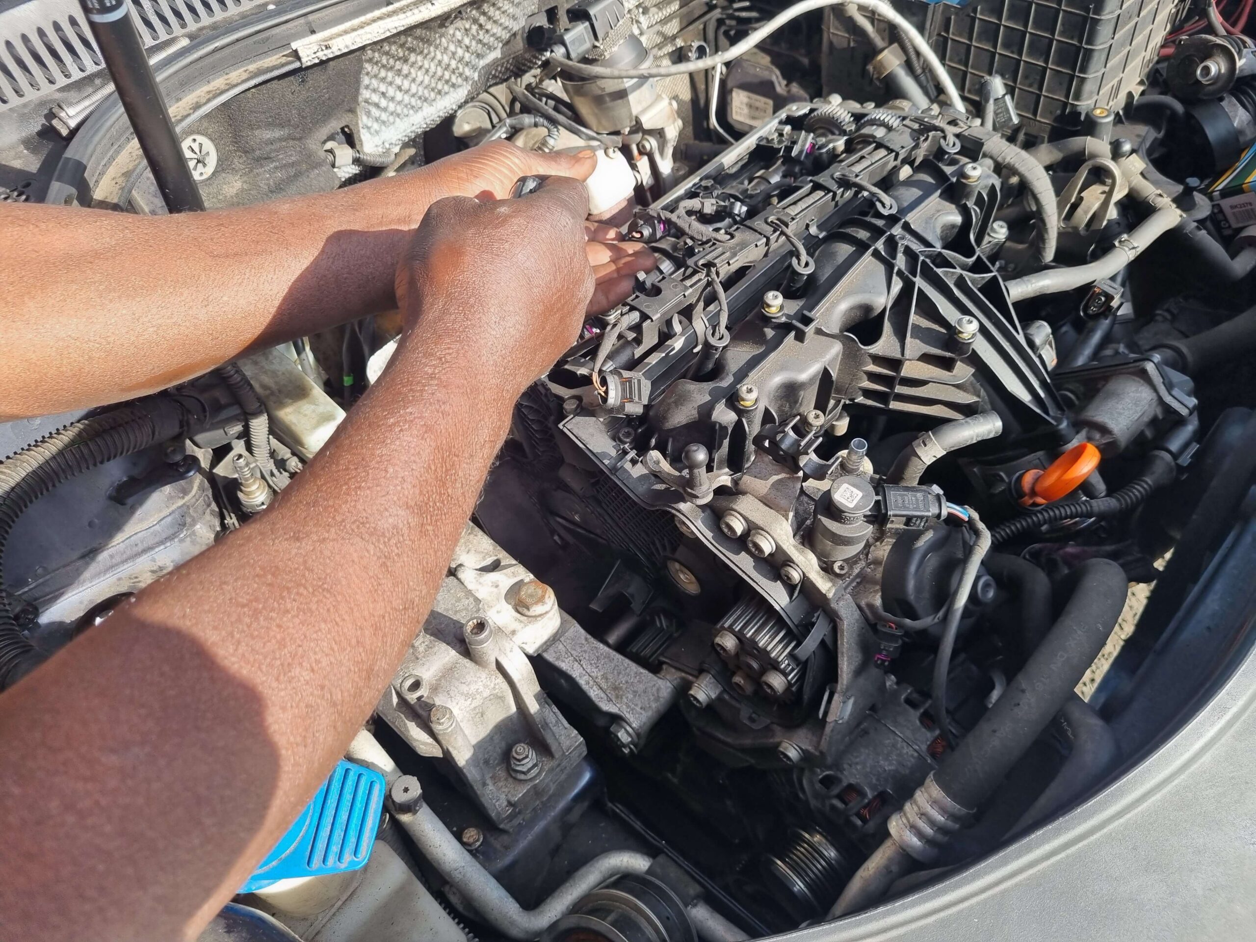 Mechanic inspecting engine at MB Autos garage